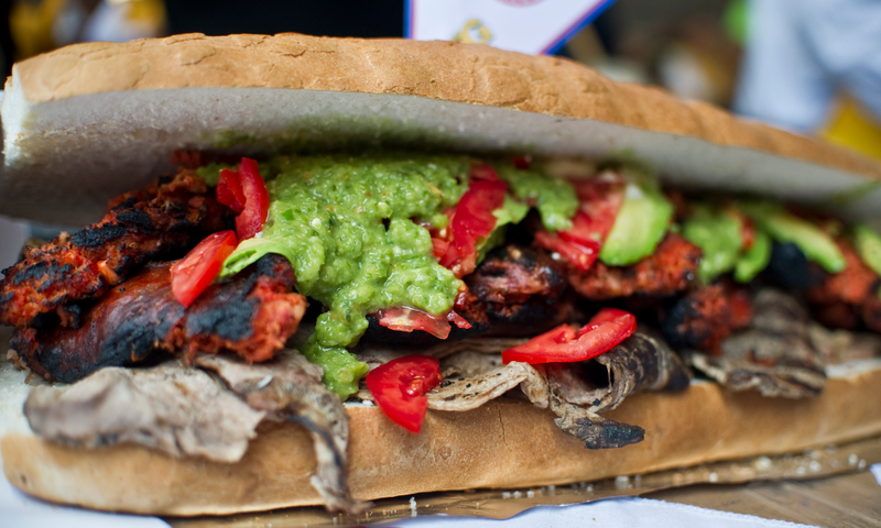 A giant torta that includes chicken, turkey, ham, shrimp, octopus, avocado and mole. (Photo: Ronaldo Schemidt/AFP/GettyImages)